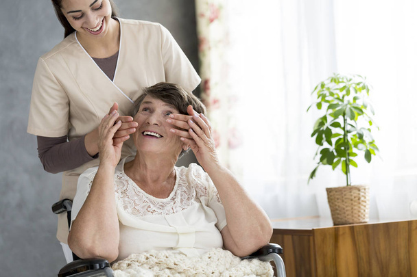 Nurse surprising a senior patient in a nursing home - Fotografie, Obrázek
