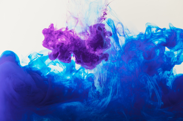 abstract texture with blue and purple paint flowing in water - Photo, Image