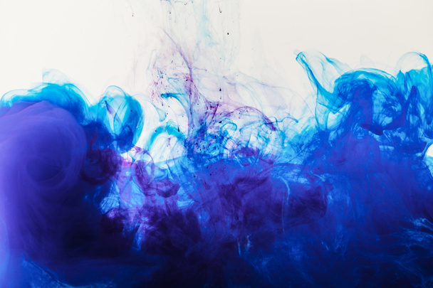 artistic background with blue and purple paint mixing in water - Fotografie, Obrázek