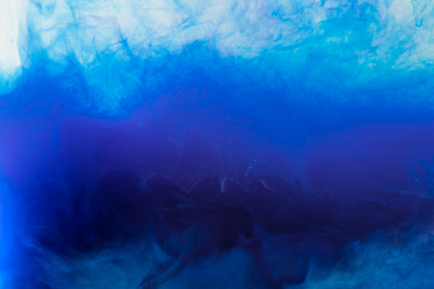 artistic background with flowing blue smoky paint in water - Photo, Image