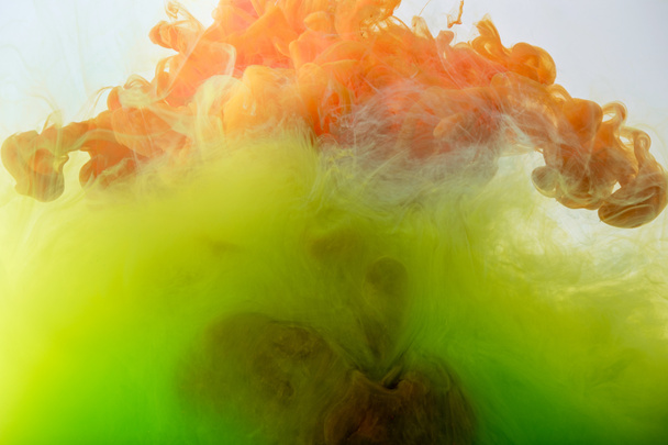 artistic texture with flowing green, yellow and orange paint - Foto, afbeelding