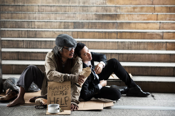 Homeless give beer to sad businessman - Photo, Image