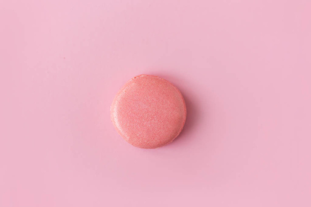 almond pink macaroon on pink background, top view  - Photo, image