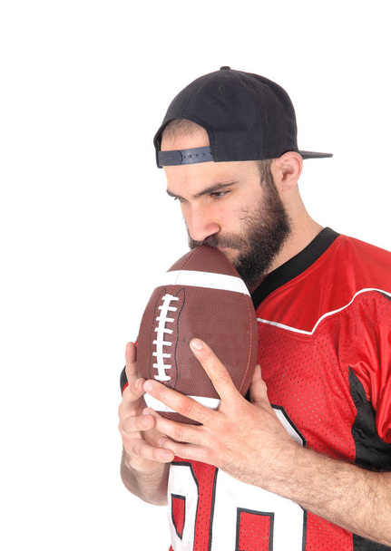 Football player holding his ball on his mouth, thinking - Valokuva, kuva