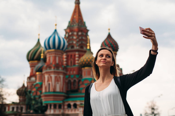 Cute girl makes a selfie with beautiful building - Photo, Image