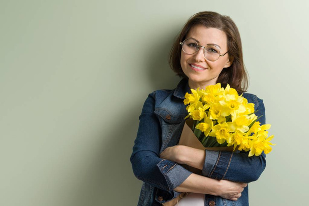 Mature happy woman holding bouquet with flowers - Fotografie, Obrázek