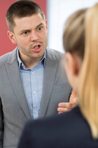 Aggressive Businessman Bullying Female Colleague In Office - Foto, immagini