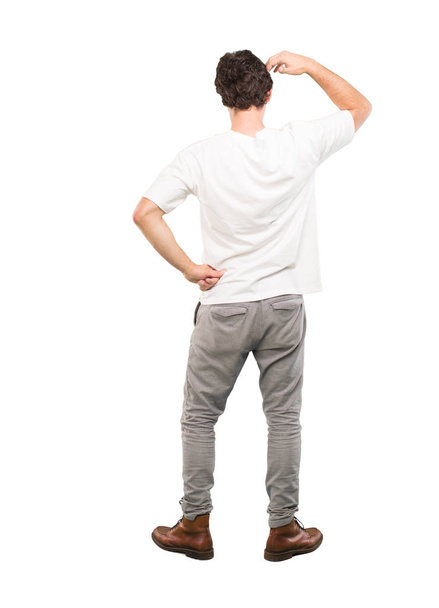 young crazy man thinking confused. Full body cutout person against white background. - Foto, Imagen