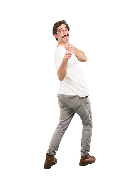 Young crazy man surprised. Full body cutout person against white background. - Foto, Imagem
