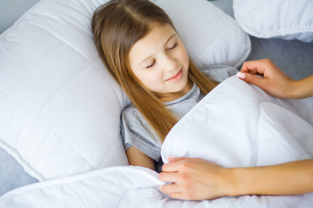 Happy little girl in morning bed - Photo, Image