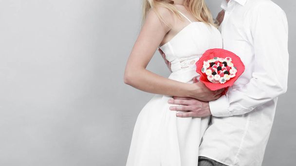 Closeup of couple with candy bunch flowers. Love. - Fotografie, Obrázek
