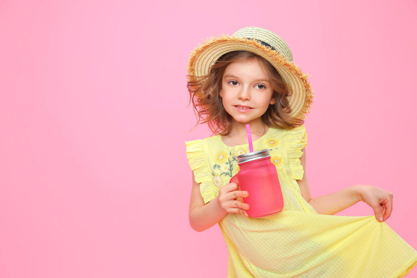Stylish little girl with drink on pink - Fotografie, Obrázek