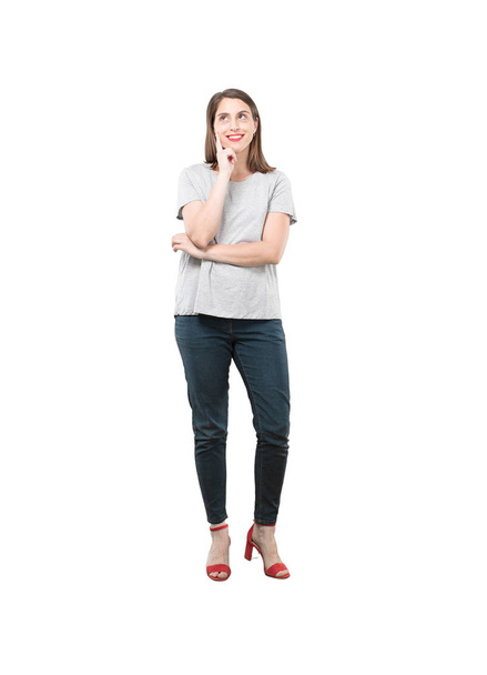 Young pretty woman thinking confused. Full body cutout person against white background. - Zdjęcie, obraz