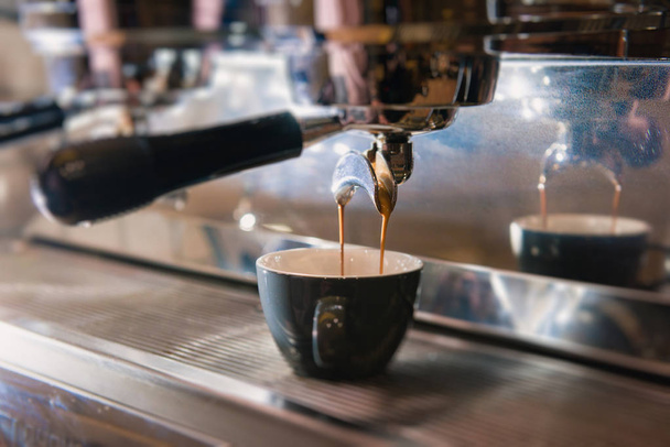 コーヒーをマシンからカップに注ぐ - 写真・画像
