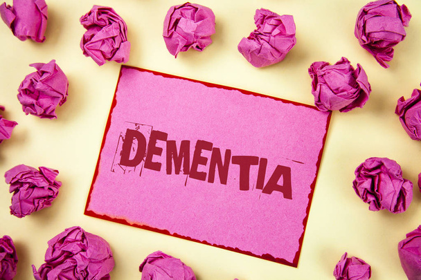 Writing note showing  Dementia. Business photo showcasing Long term memory loss sign and symptoms made me retire sooner written on Pink Sticky Note Paper on plain background Pink Paper Balls. - Photo, Image