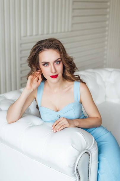beautiful young woman posing in studio wearing blue dress  - Fotografie, Obrázek