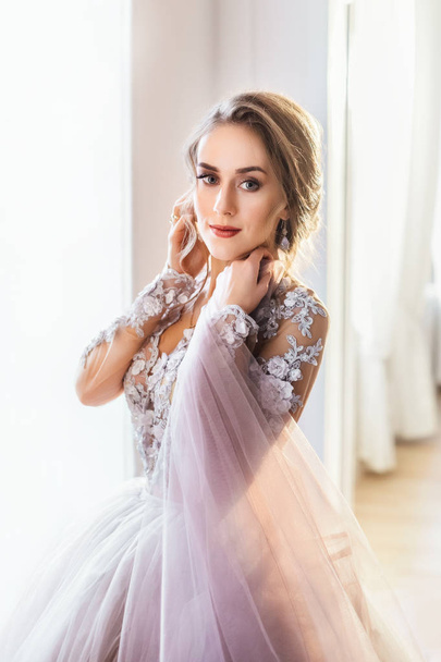 young beautiful bride in gorgeous dress posing indoors  - Photo, Image