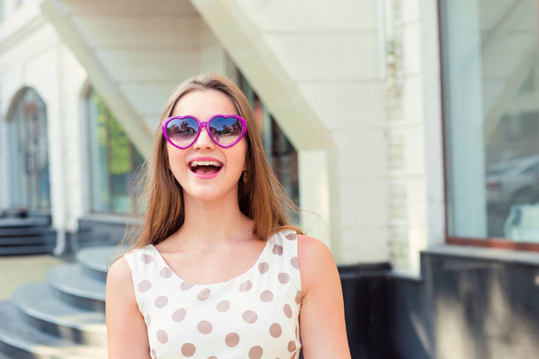 girl with long hair heart-shaped sunglasses laughing - Фото, зображення