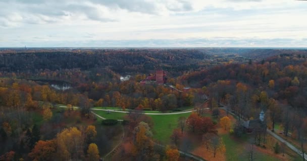 Turaides Castle Autumn Forest Sigulda city nature, Gauya river drone flight, bridge car drive from above - Footage, Video