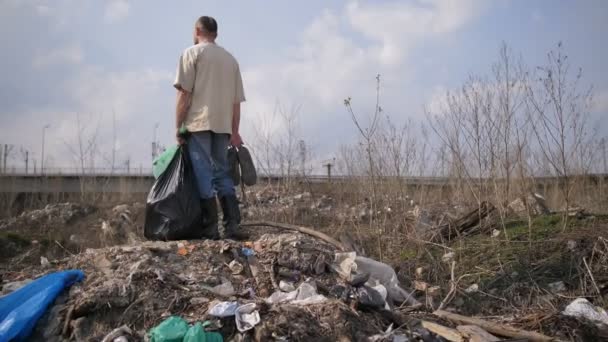 Man standing on garbage hill at landfill site - Footage, Video