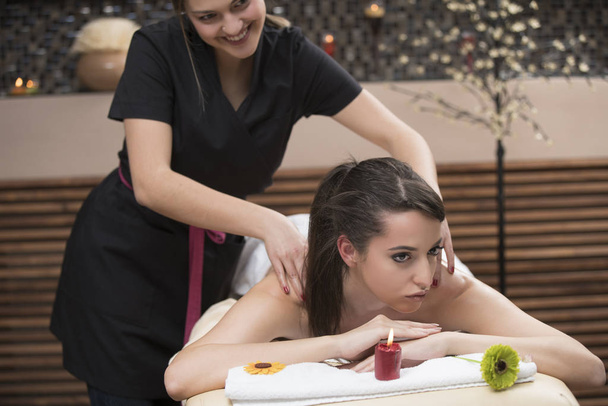 Spa woman. Female enjoying relaxing back massage in cosmetology spa centre. Body care, skin care, wellness, wellbeing, beauty treatment concept. - Photo, Image