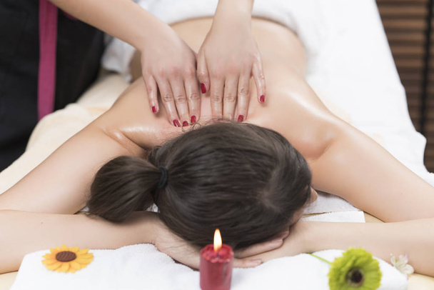Beautiful young woman relaxing massage - 写真・画像