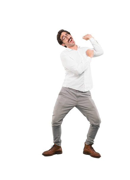 Young crazy man dancing. Full body cutout person against white background. - Valokuva, kuva