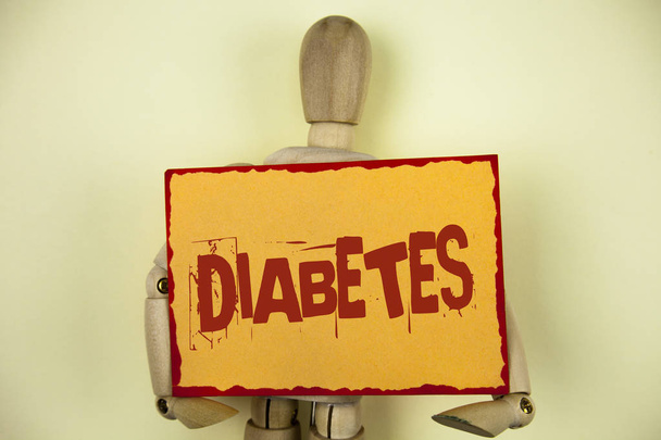 Conceptual hand writing showing Diabetes. Business photo text Medical condition diagnosed with increased high level sugar written on Sticky Note paper on plain background Wooden Robot Toy. - Photo, Image