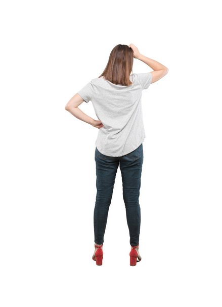 Young pretty woman thinking confused. Full body cutout person against white background. - Photo, image