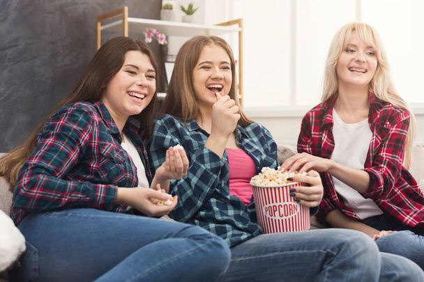 Laughing women watching movie at home - Foto, imagen