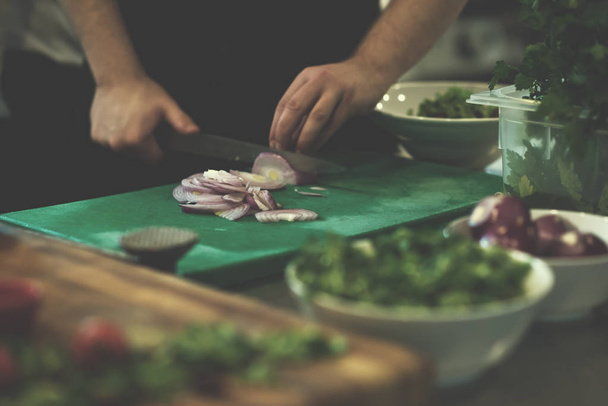 Chef  hands cutting the onion with knife - Φωτογραφία, εικόνα