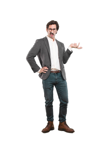 young crazy man thinking confused. Full body cutout person against white background. - Photo, image