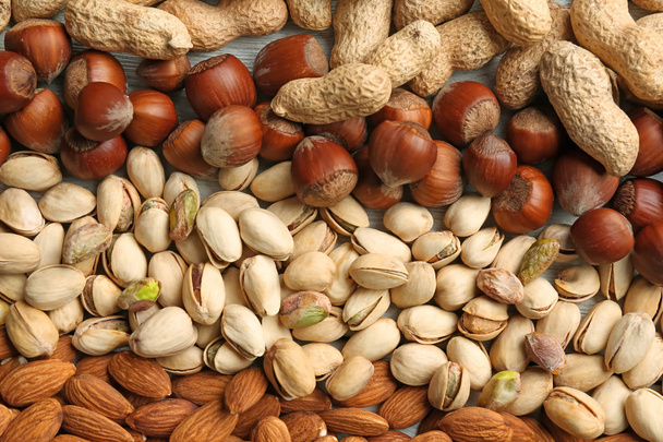 Many different nuts as background - Φωτογραφία, εικόνα
