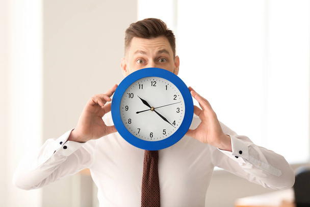 Businessman with clock in office. Time management concept - Photo, Image