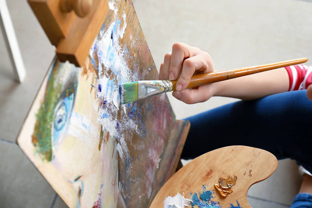 Female artist painting in workshop, closeup - Фото, зображення