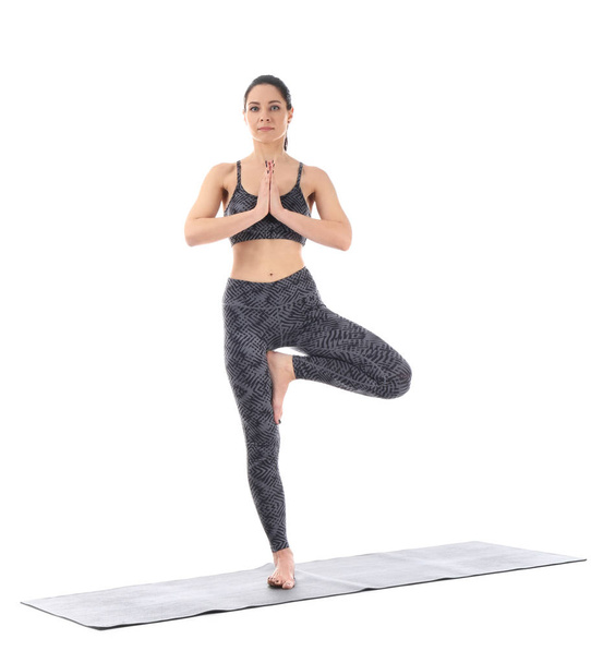Young woman practicing yoga on white background - Zdjęcie, obraz