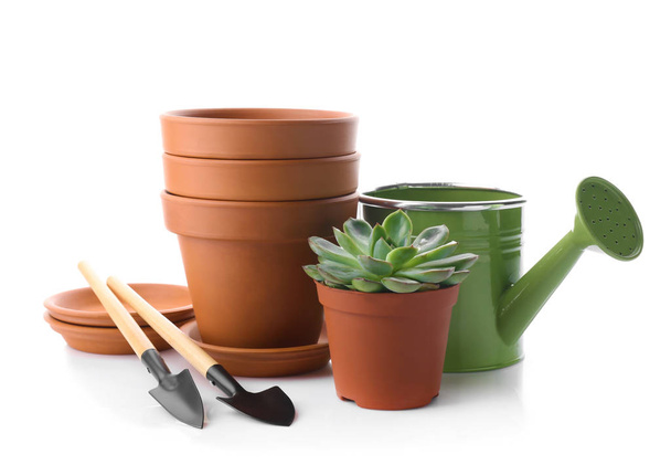 Empty pots with gardening tools on white background - Photo, Image