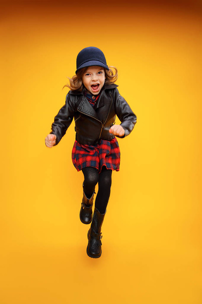 Jumping girl in fashionable clothes - Фото, зображення