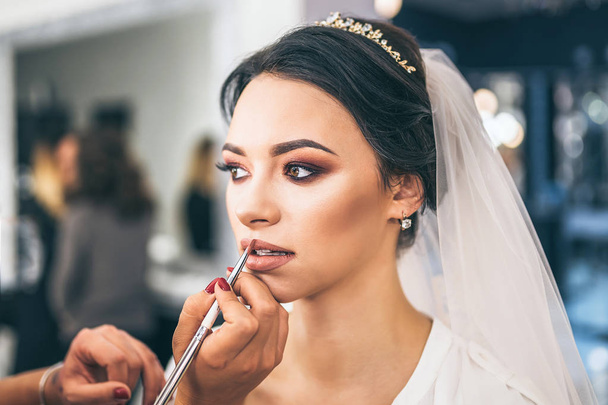 Beautiful bride on makeup before wediing  - Fotó, kép