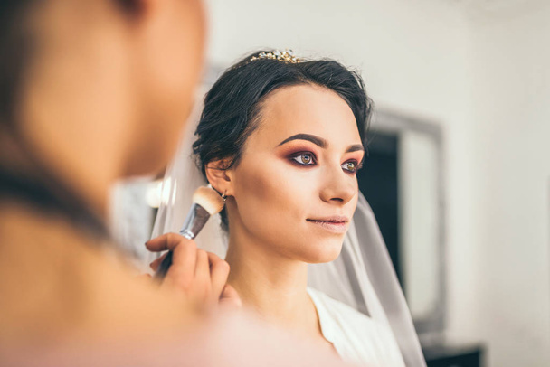 Beautiful bride on makeup before wedding  - Fotó, kép