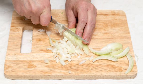 Cook chopped onion on the board - Φωτογραφία, εικόνα