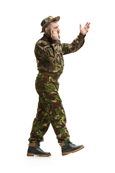 Young army soldier wearing camouflage uniform isolated on white - Photo, Image
