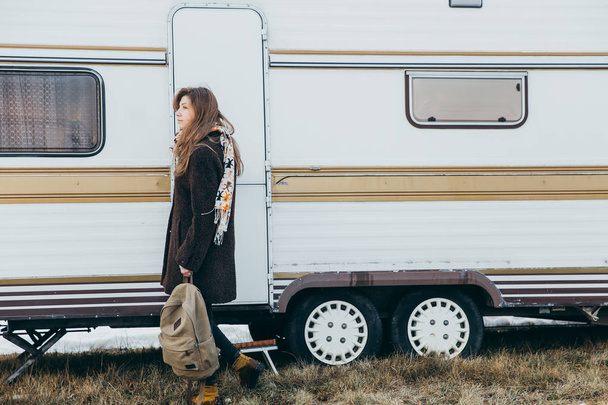 Young woman near the white trailer - Valokuva, kuva