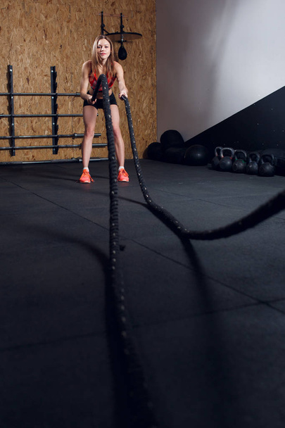 Image of young athlete girl in training with two ropes - Photo, Image