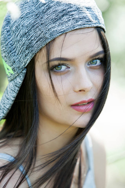 Beautiful girl with green eyes in city park. Woman beauty face portrait.  - Zdjęcie, obraz
