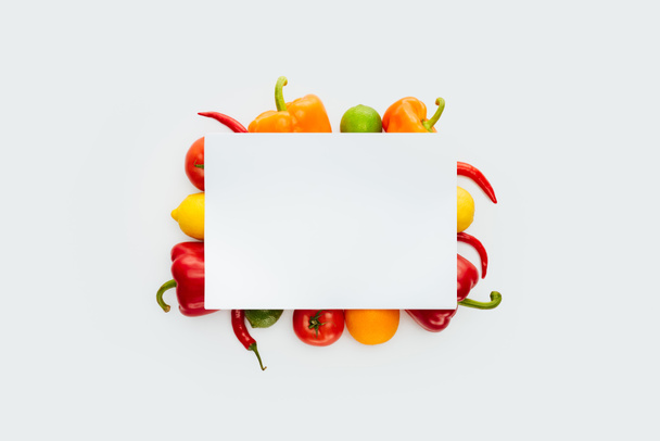 top view of blank placard on vegetables and fruits isolated on white - Photo, Image