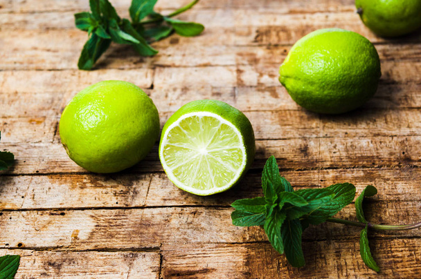 Lime slices on rustic wooden background - Photo, Image