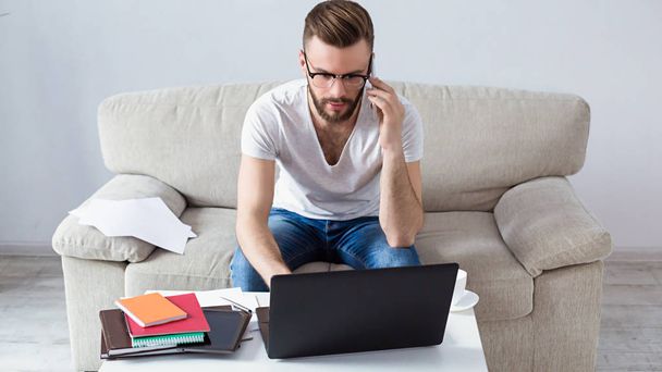 man freelancer using laptop at home  - Fotó, kép