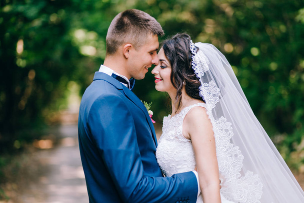beautiful  couple of newlyweds embracing    in garden  - Fotografie, Obrázek
