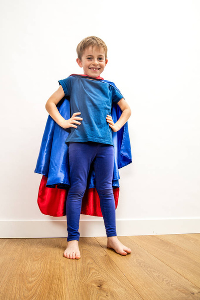 proud super hero boy staring playing with hands on hips for kid power, happiness and child body language, low angle view - Photo, Image